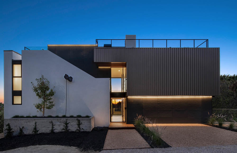 Contemporary home exterior with integrated LED accent lighting at dusk