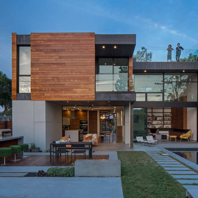 Modern residence with integrated LED strip lighting along a poolside deck